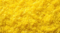 pngtree-vibrant-yellow-rice-artfully-arranged-on-a-textured-background-image_13871315